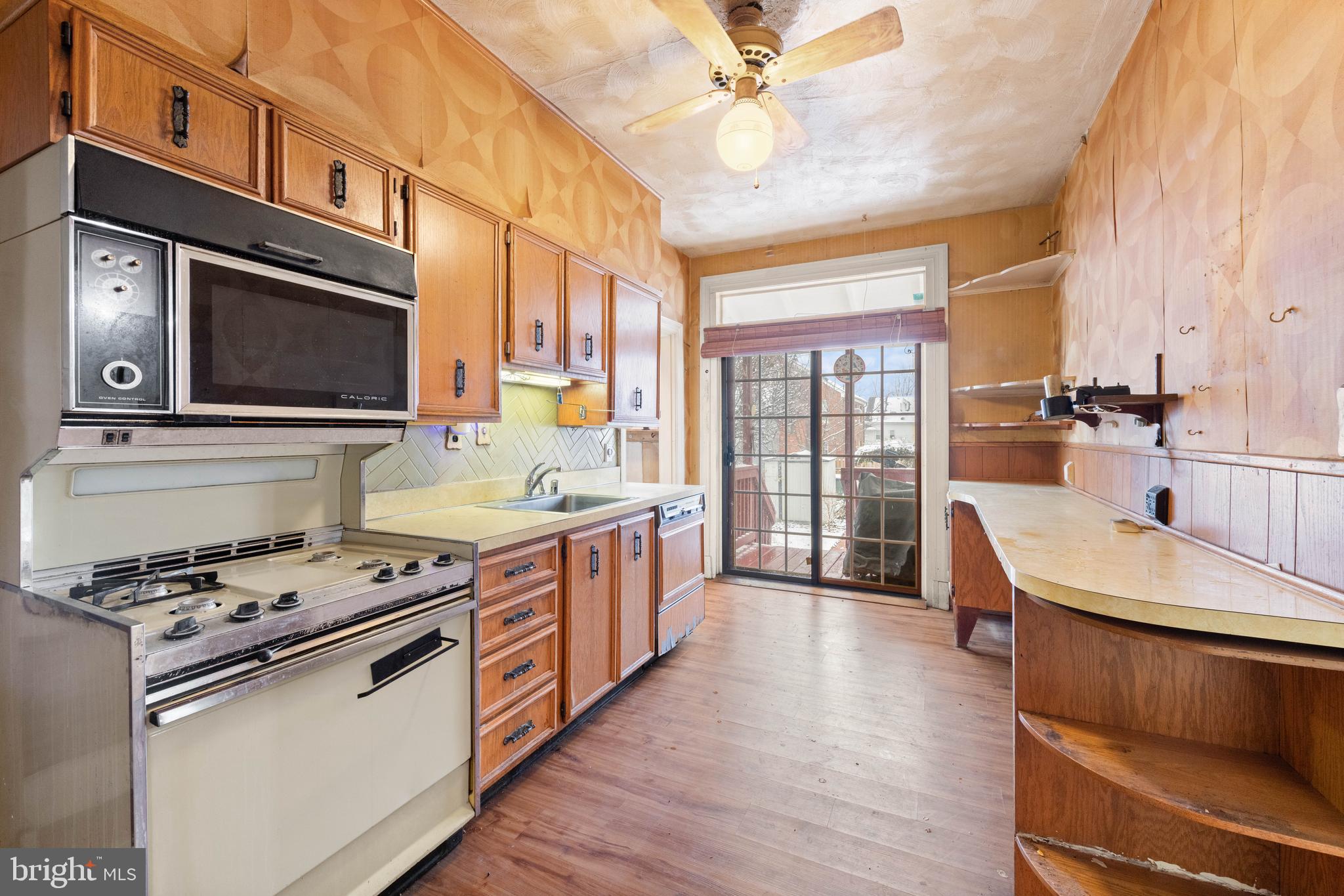 1702 Webster Street Northwest Washington, DC 20011 - Photo 13 of 42 a kitchen with stainless steel appliances granite countertop a sink stove and wooden cabinets