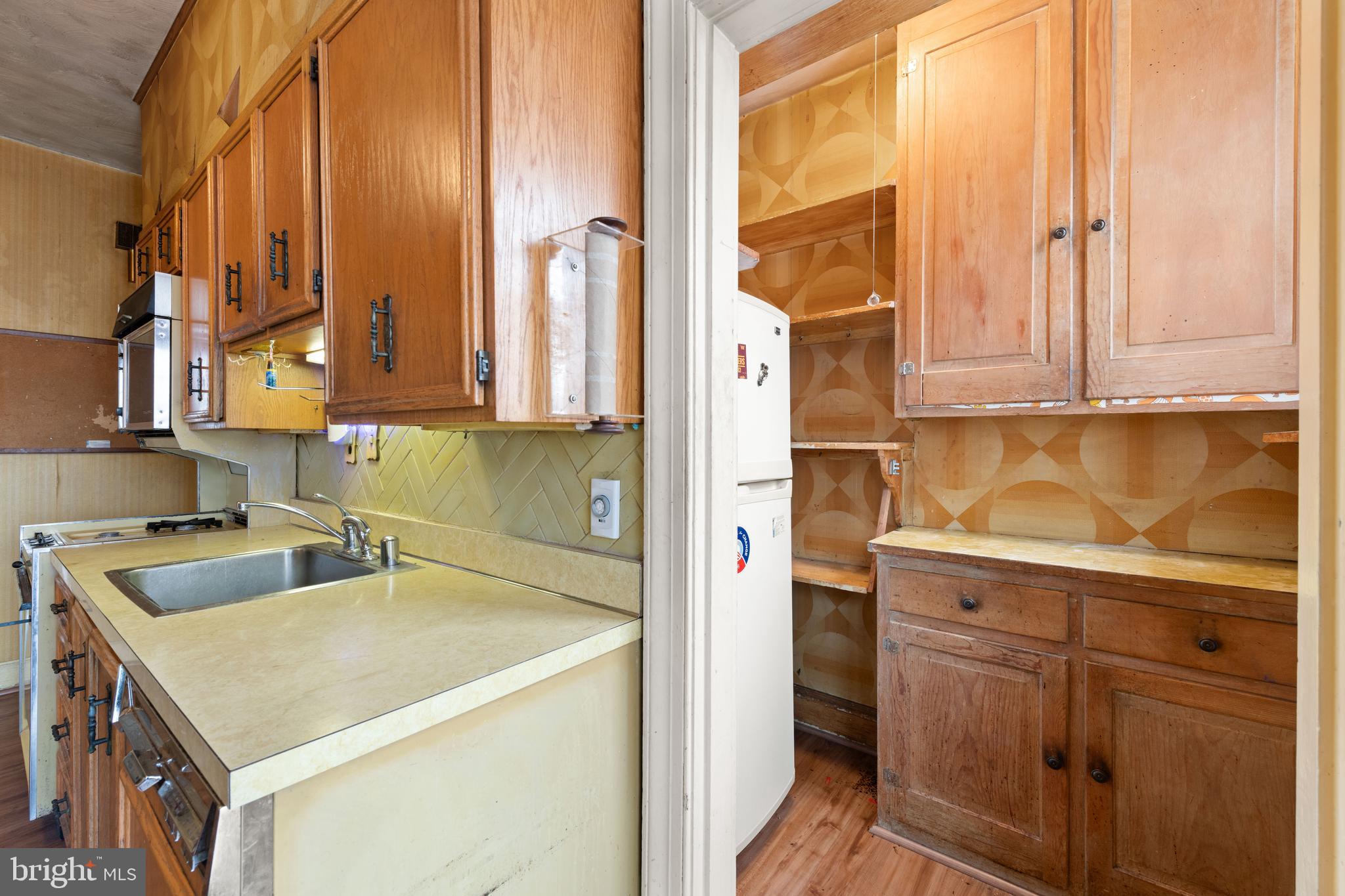 1702 Webster Street Northwest Washington, DC 20011 - Photo 15 of 42 a kitchen with a sink a stove and cabinets