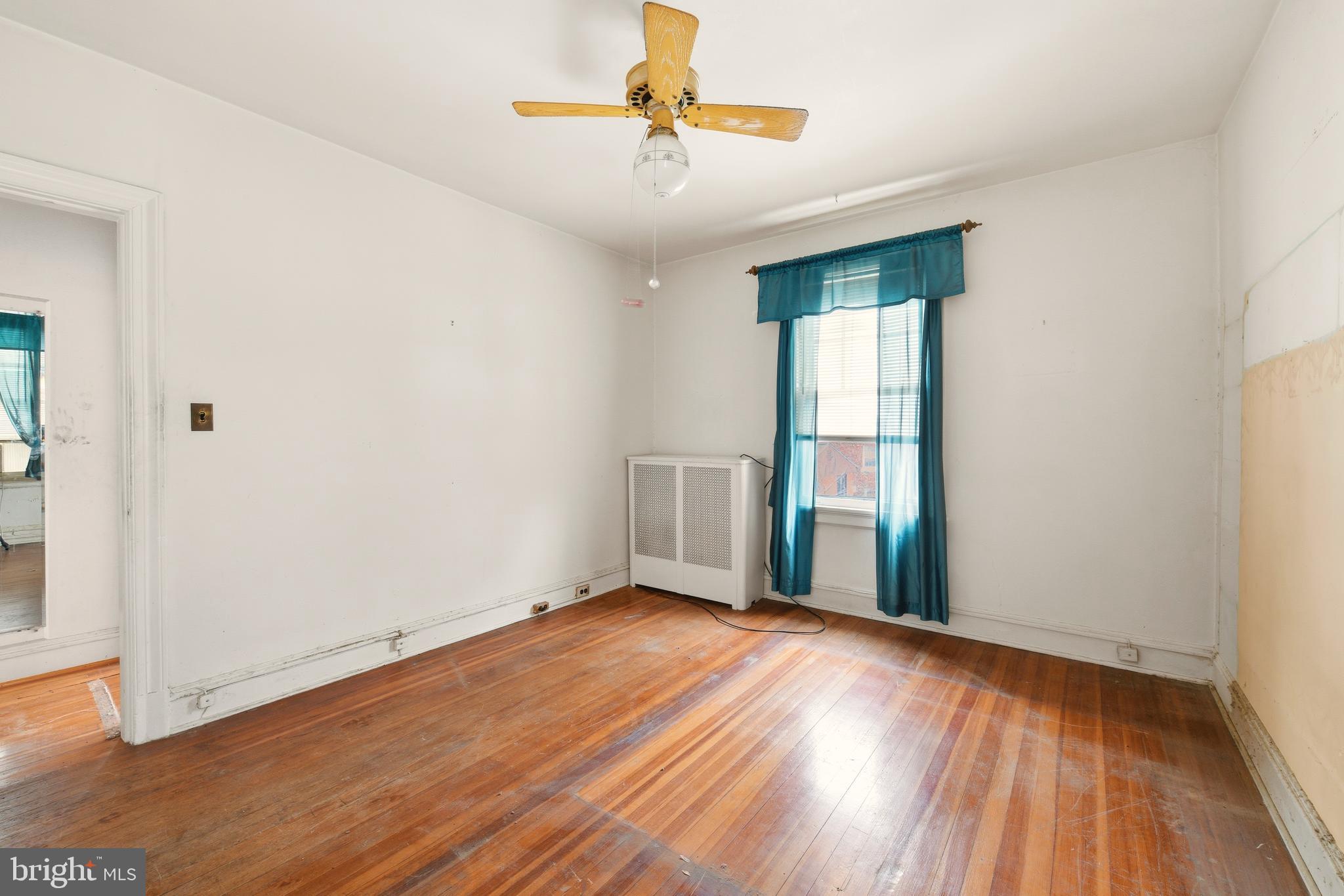 1702 Webster Street Northwest Washington, DC 20011 - Photo 23 of 42 wooden floor in an empty room with a window
