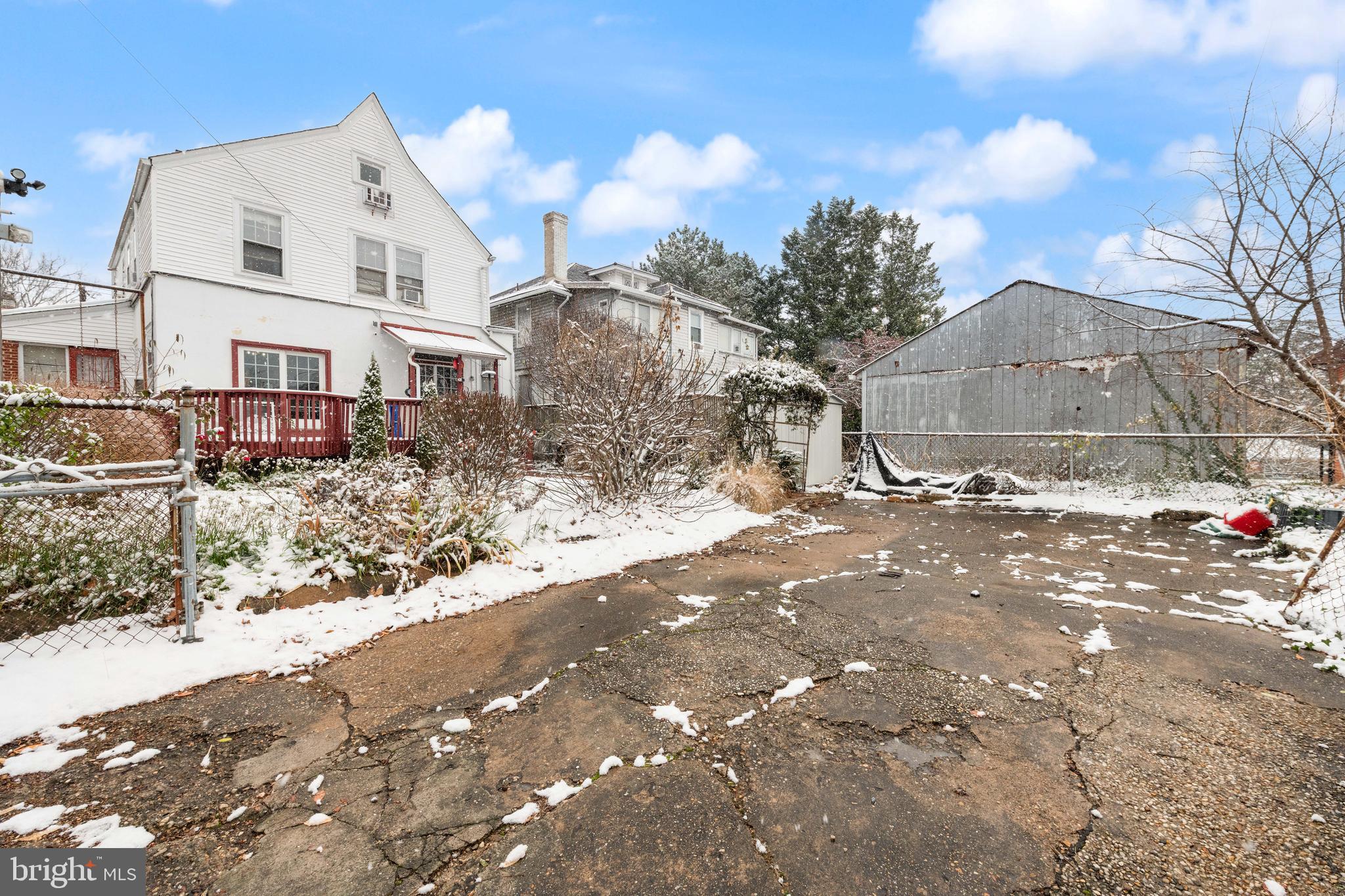1702 Webster Street Northwest Washington, DC 20011 - Photo 37 of 42 a view of a white house with a yard covered in snow