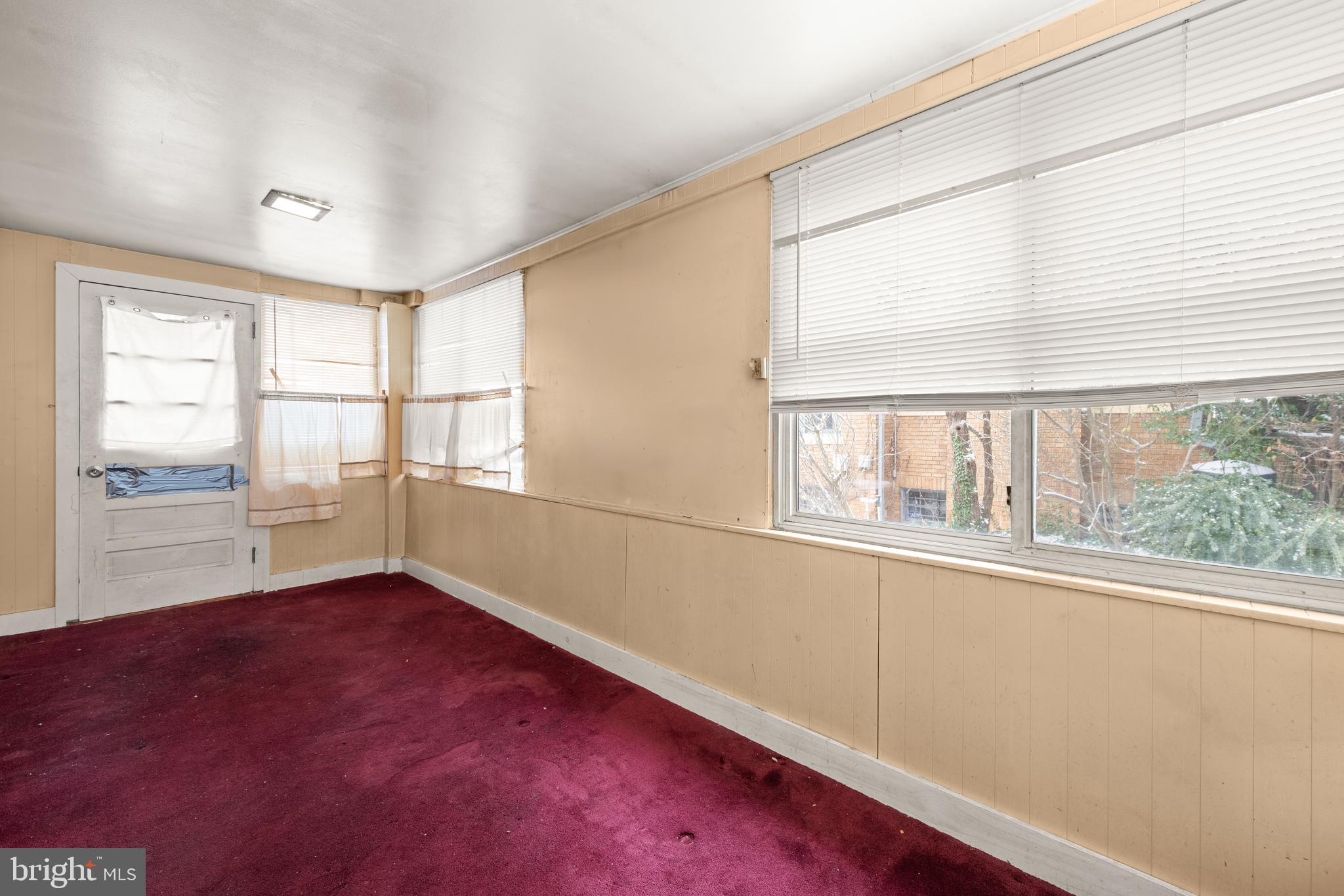 1702 Webster Street Northwest Washington, DC 20011 - Photo 9 of 42 an empty room with wooden floor and windows