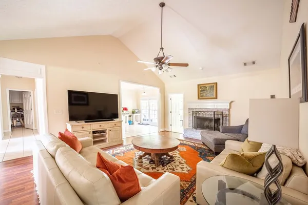 a living room with furniture a flat screen tv and a fireplace