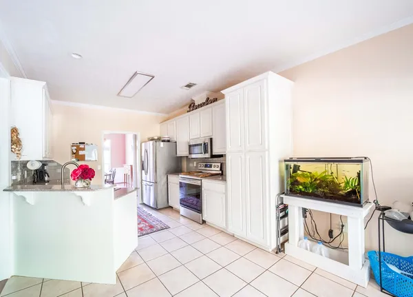 a kitchen with a refrigerator and a sink