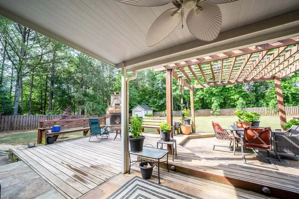 a view of a patio with lawn chairs floor to ceiling window and wooden floor