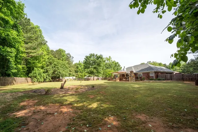 a house view with a play ground in front of it