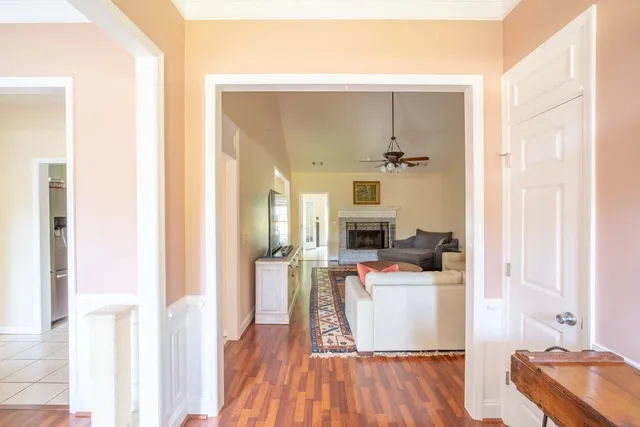 a kitchen with a sink a refrigerator and wooden floor