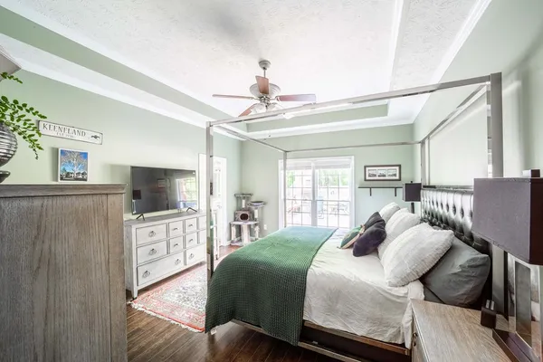 a bedroom with a bed and a flat screen tv