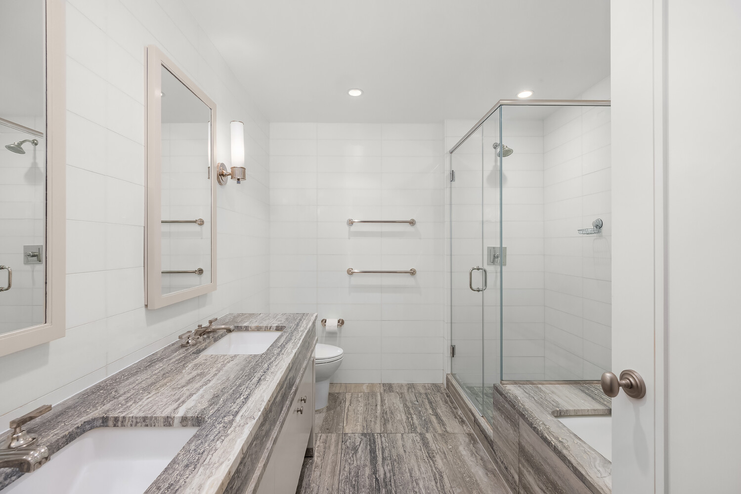 80 Riverside Boulevard, Unit 15B Manhattan, NY 10069 - Photo 13 of 26 a bathroom with a granite countertop sink a mirror and a shower