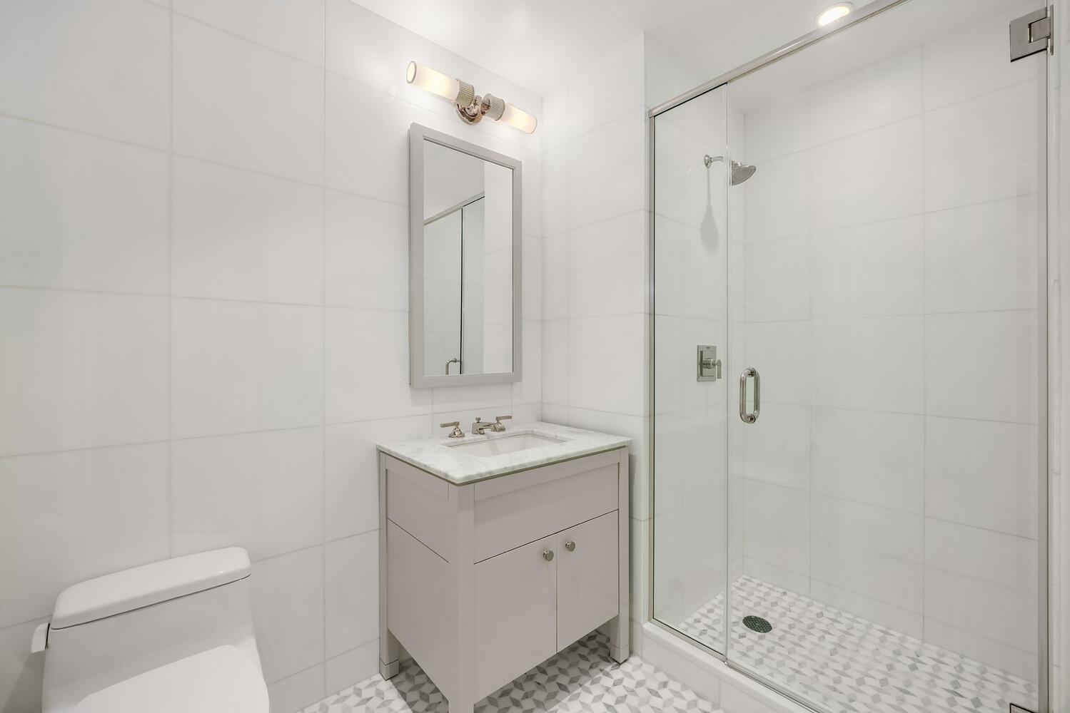 80 Riverside Boulevard, Unit 15B Manhattan, NY 10069 - Photo 16 of 26 a bathroom with a toilet sink vanity and mirror