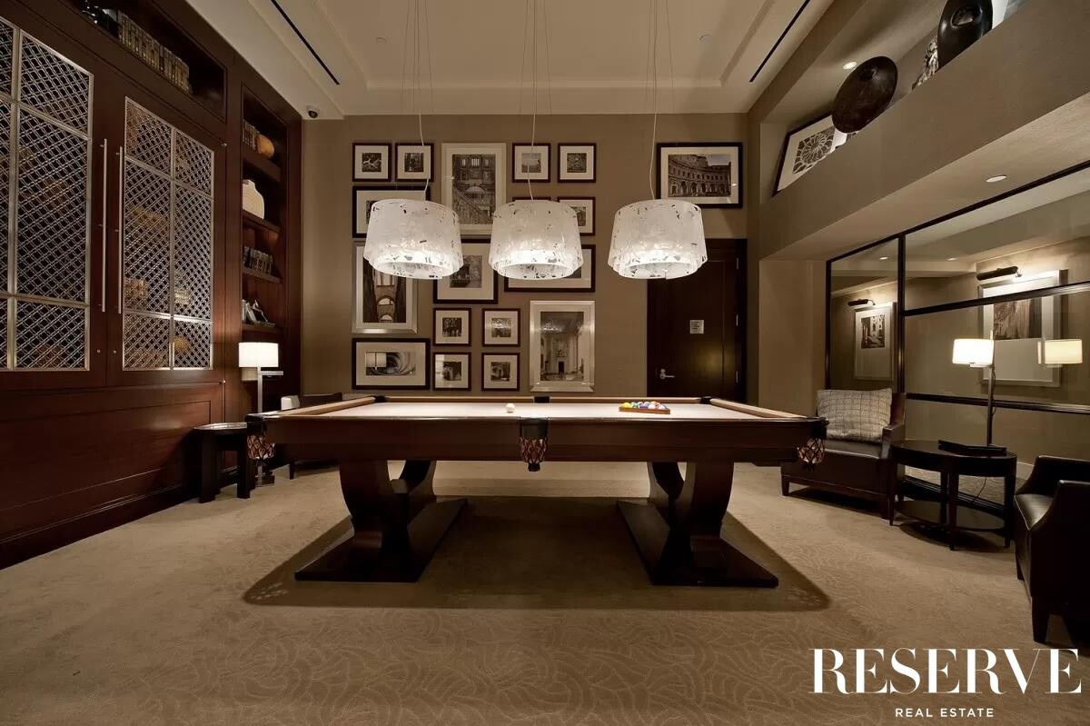 80 Riverside Boulevard, Unit 15B Manhattan, NY 10069 - Photo 24 of 26 a living room with furniture a clock on wall and windows