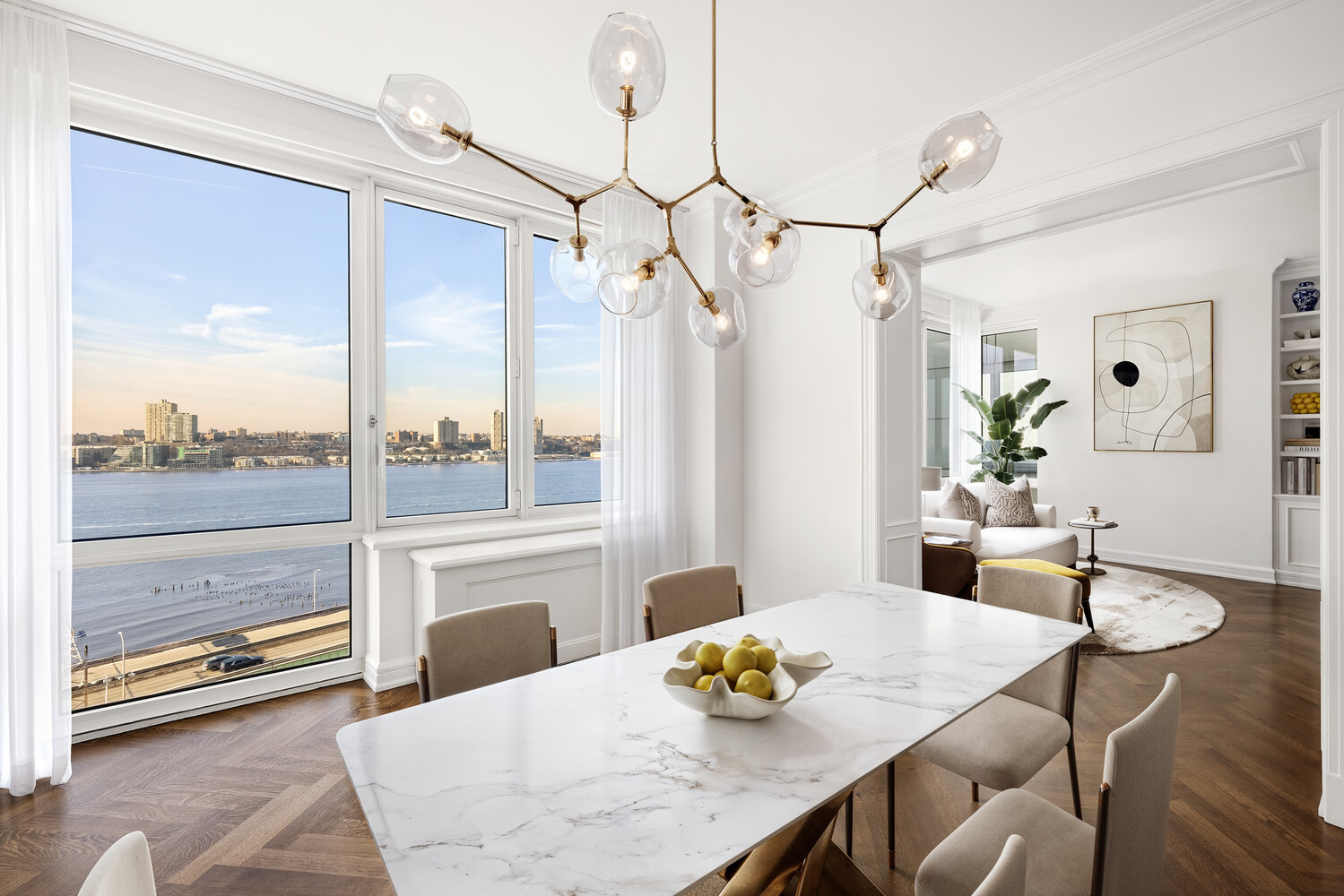 80 Riverside Boulevard, Unit 15B Manhattan, NY 10069 - Photo 5 of 26 a view of a dining room with furniture a chandelier and wooden floor