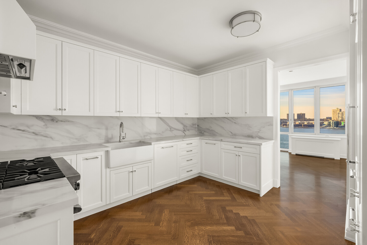80 Riverside Boulevard, Unit 15B Manhattan, NY 10069 - Photo 9 of 26 a kitchen with granite countertop white cabinets and white appliances