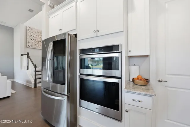 a kitchen with stainless steel appliances a stove and a cabinets
