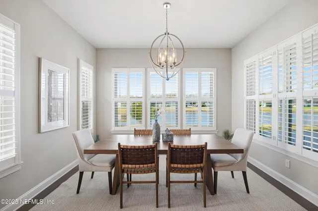 a spacious bedroom with a bed and a chandelier