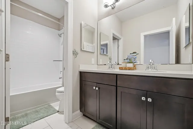 a view of a dining room and livingroom with furniture wooden floor a chandelier