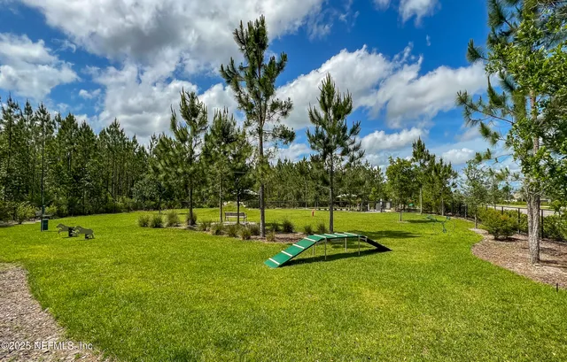 a view of a backyard with sitting area