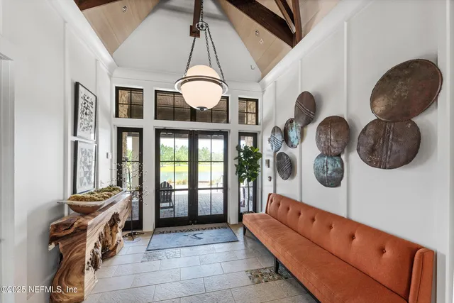 a dining room with furniture a chandelier and wooden floor