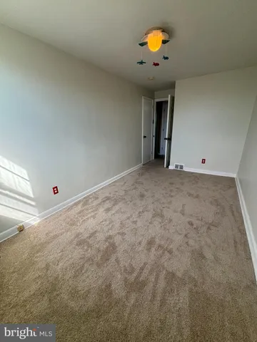 a view of empty room with a fireplace