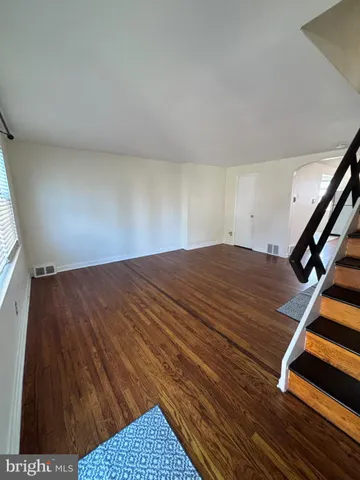 a view of a room with wooden floor
