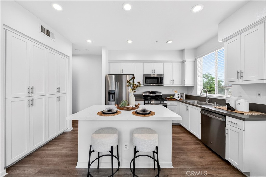 156 North Orange Avenue Brea, CA 92821 - Photo 12 of 44 a kitchen with refrigerator cabinets and wooden floor