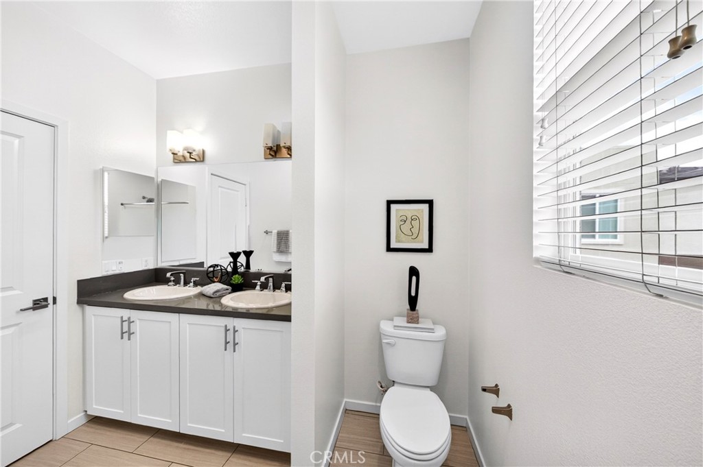 156 North Orange Avenue Brea, CA 92821 - Photo 30 of 44 a bathroom with a granite countertop toilet sink and mirror