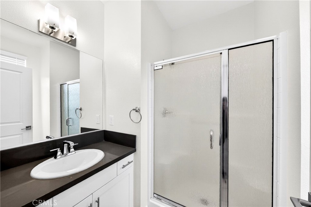 156 North Orange Avenue Brea, CA 92821 - Photo 35 of 44 a bathroom with a granite countertop sink mirror and a shower