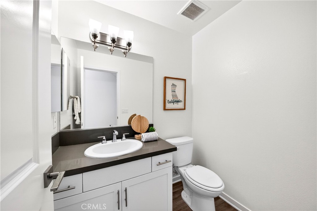 156 North Orange Avenue Brea, CA 92821 - Photo 40 of 44 a bathroom with a toilet a sink and mirror