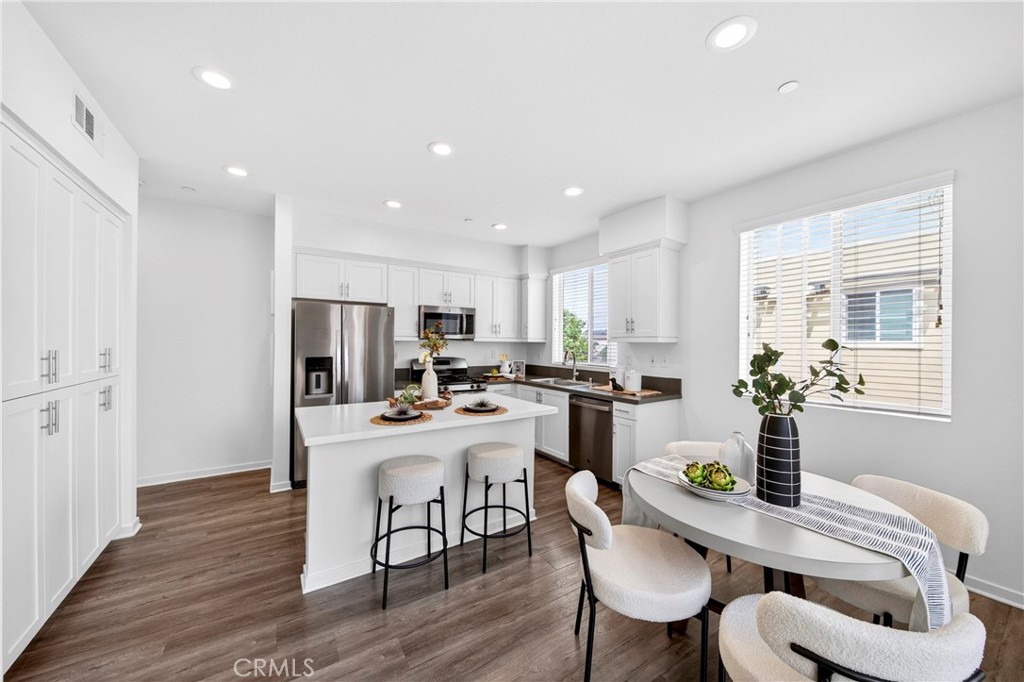 156 North Orange Avenue Brea, CA 92821 - Photo 10 of 44 a room with stainless steel appliances kitchen island granite countertop a dining table chairs and granite counter tops
