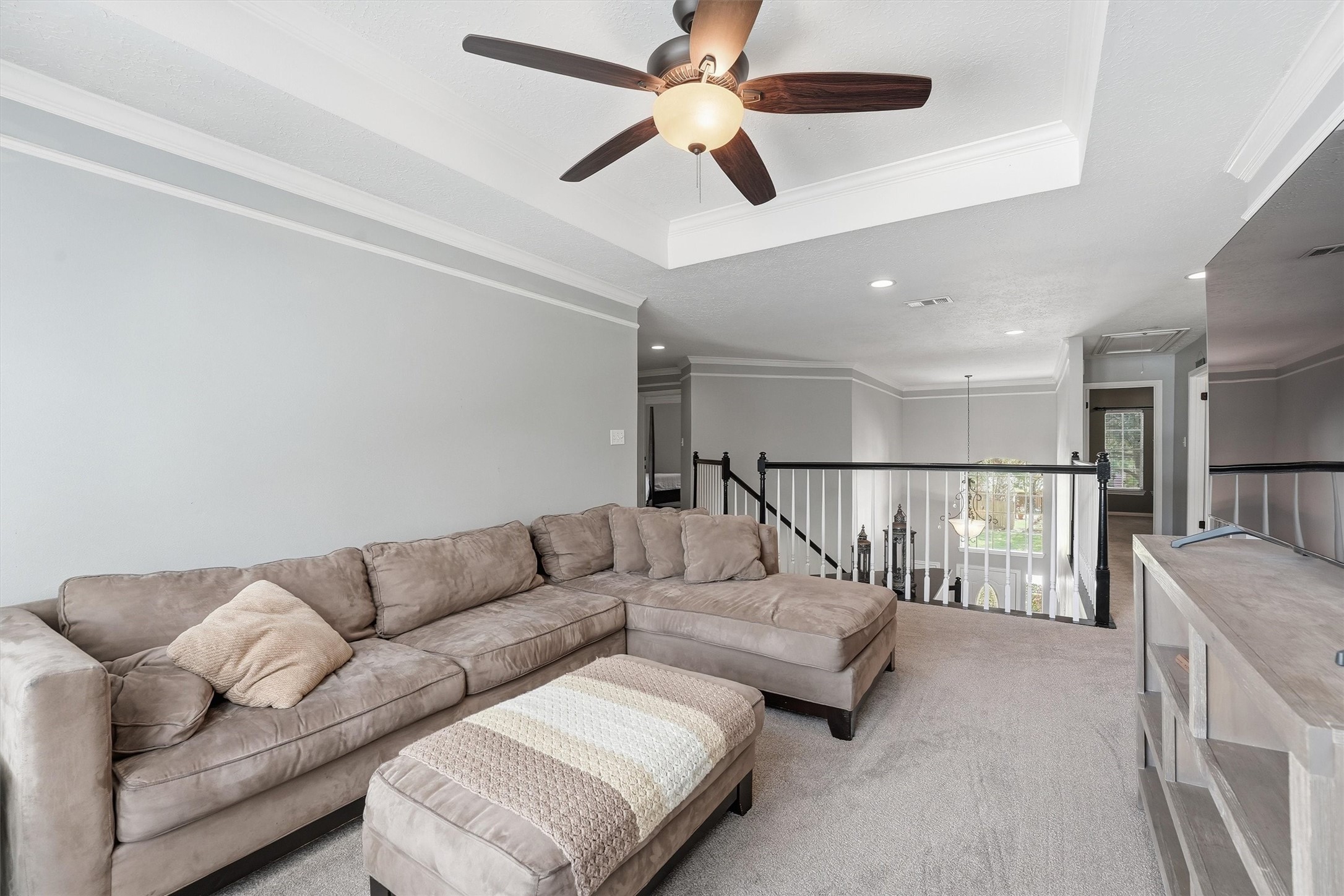 8827 Mile Run Road Humble, TX 77346 - Photo 17 of 37 a living room with furniture and a ceiling fan