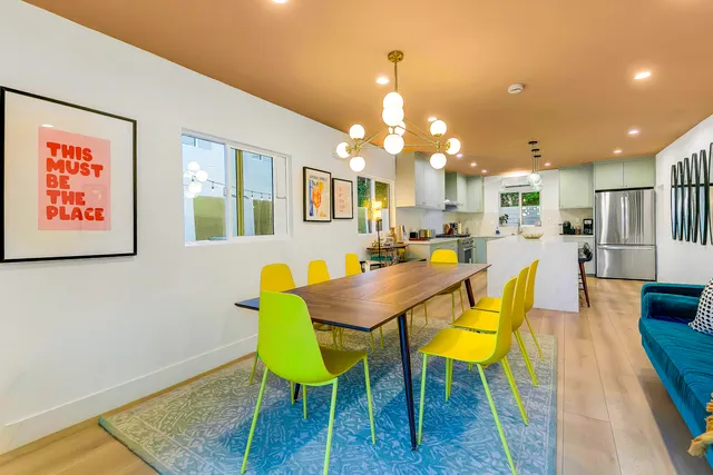 a living room with furniture and kitchen view