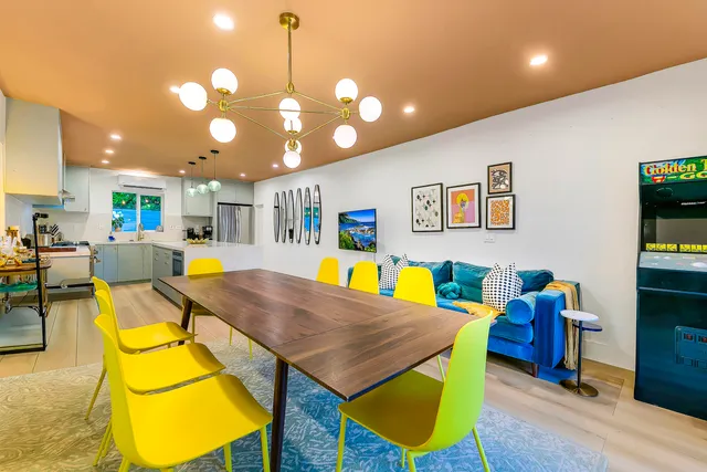 a kitchen with stainless steel appliances and dining table