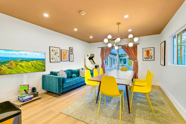 a kitchen with stainless steel appliances kitchen island a refrigerator sink and cabinets