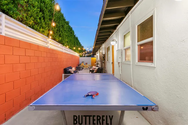 a view of a patio with table and chairs with wooden floor