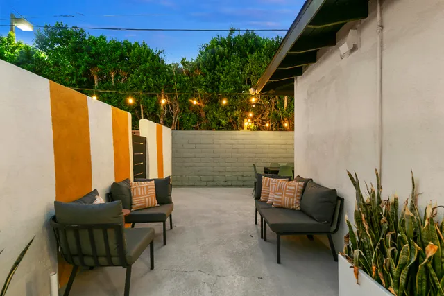 a view of an chairs and tables in the backyard