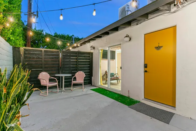 a front view of a house with yard and furniture