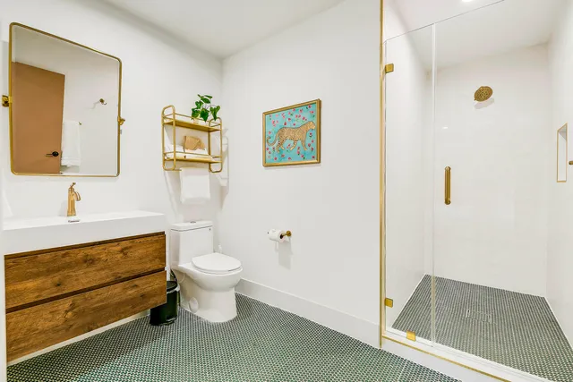 a kitchen with kitchen island a stove a refrigerator and a sink