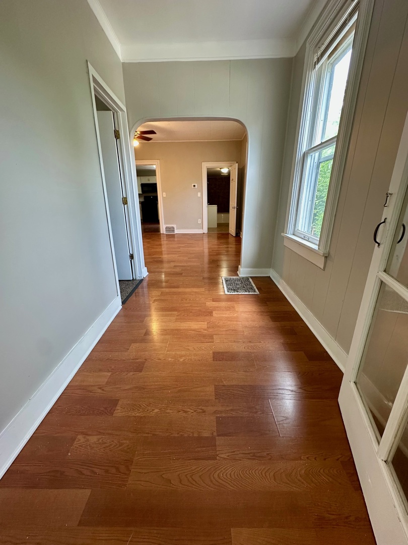 50 Sheridan Street Elgin, IL 60123 - Photo 14 of 21 a view of a hallway with wooden floor and a fireplace