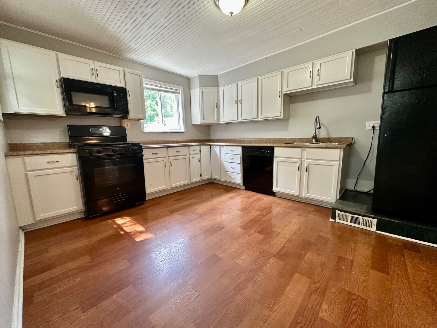 50 Sheridan Street Elgin, IL 60123 - Photo 16 of 21 a kitchen with granite countertop a stove top oven a sink dishwasher and a refrigerator with wooden floor