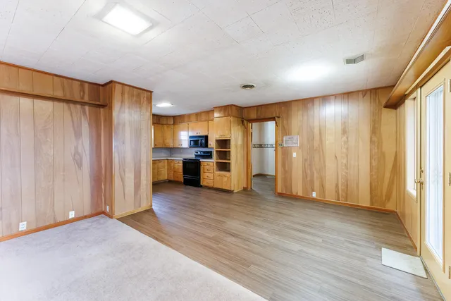 a view of a kitchen with a sink and dishwasher kitchen view with wooden floor