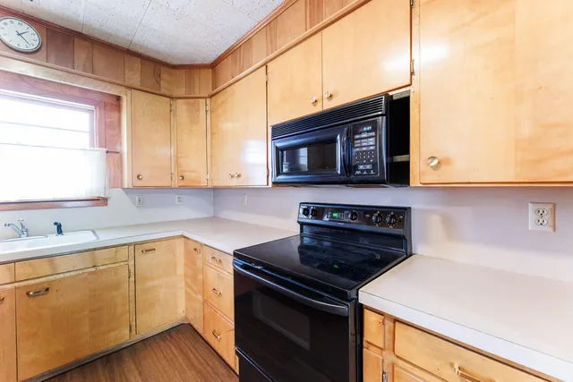 a kitchen with stainless steel appliances a stove microwave and cabinets