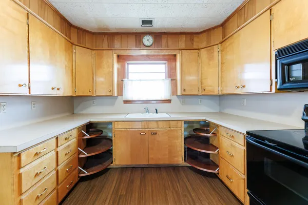 a kitchen with stainless steel appliances white cabinets and a stove top oven