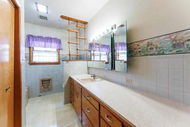 a bathroom with a sink and a mirror
