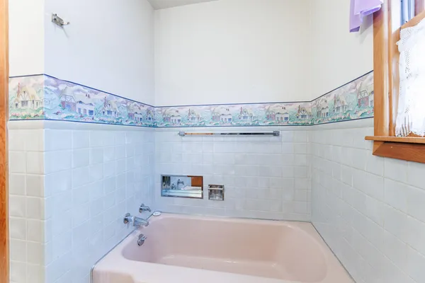 a bathroom with a bathtub and shower