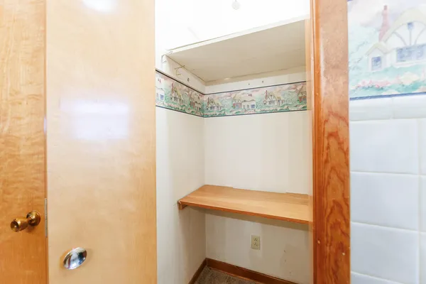 a view of a kitchen with a closet and wooden floor