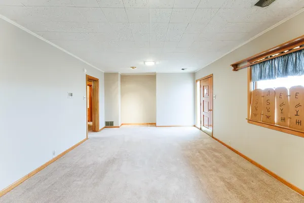 a view of an empty room with a window