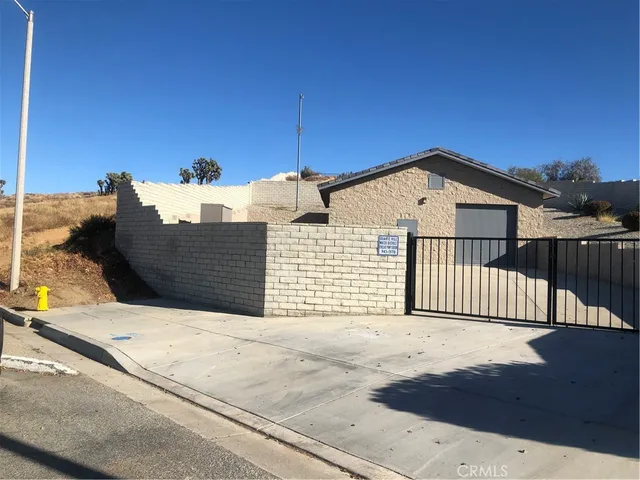 a view of a house with a wooden fence