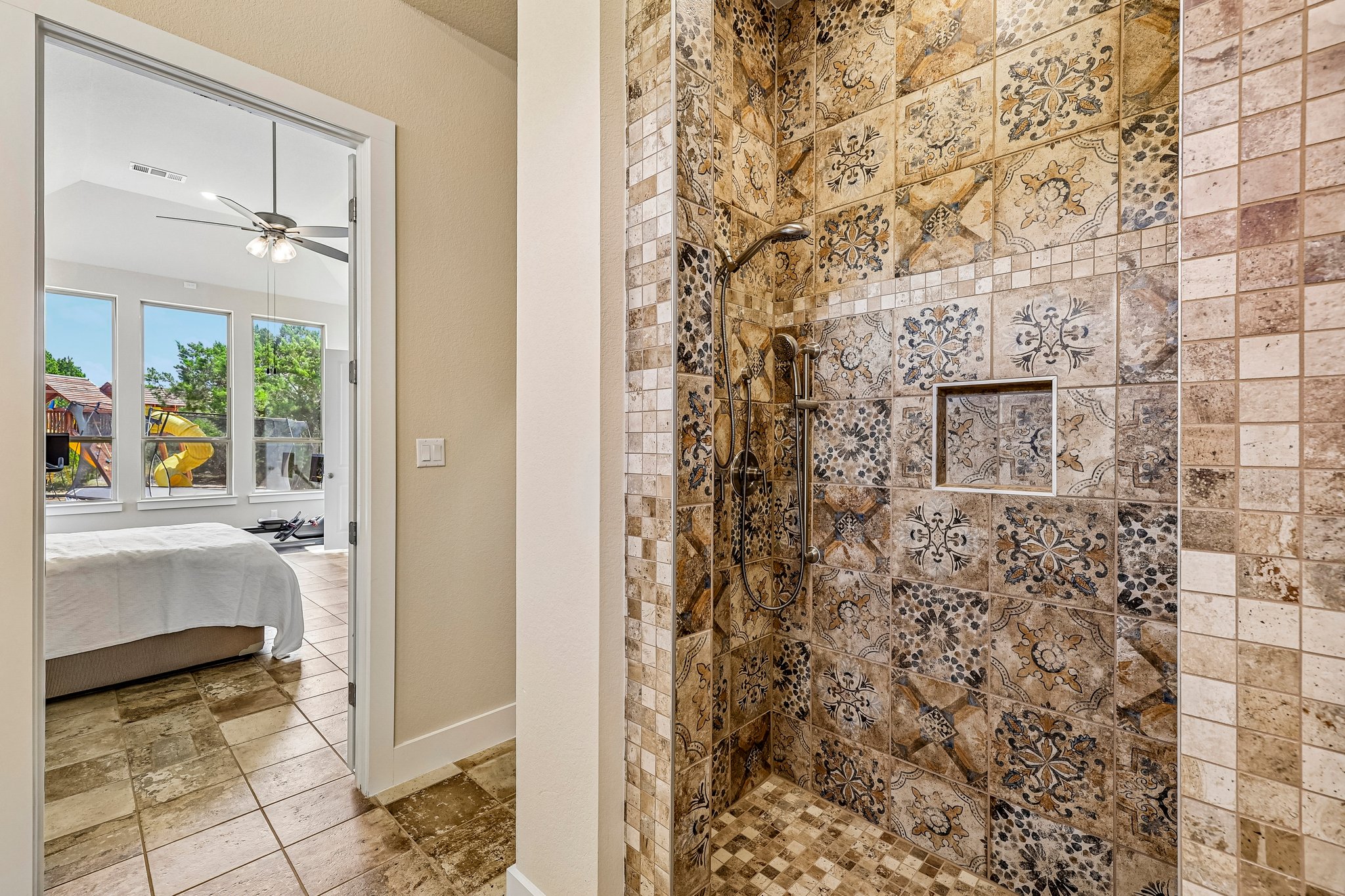 1705 Parten Rnch Parkway Austin, TX 78737 - Photo 26 of 39 Ornate tile work defines this walk-in shower, offering a refined bathing experience.