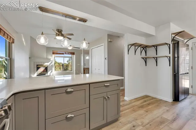 a kitchen with a sink window and cabinets
