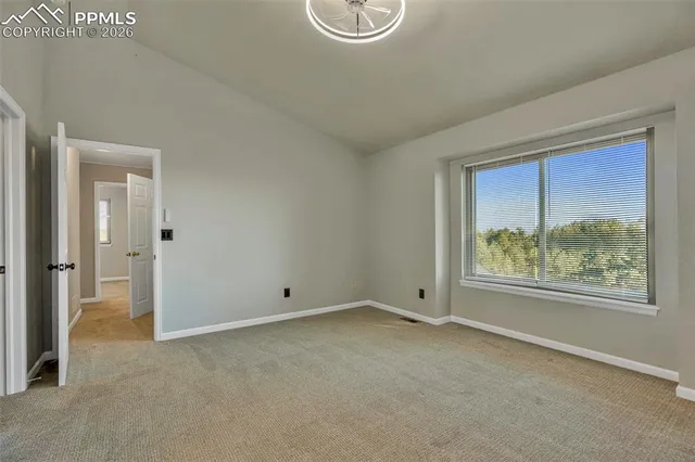 a view of a livingroom with wooden floor and a large window