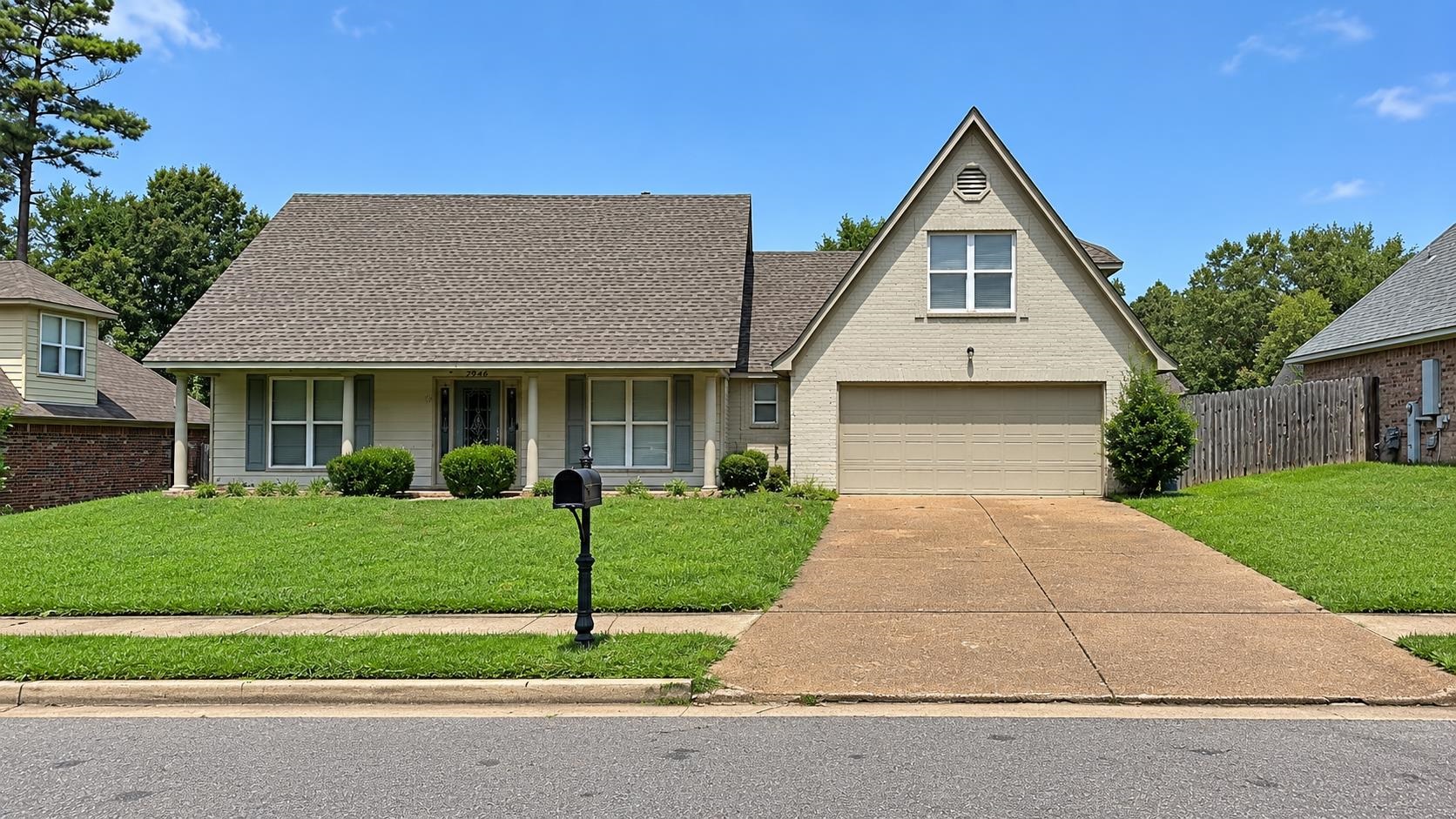 View of front of property with a front yard, a shingled roof, stucco siding, and an attached garage
